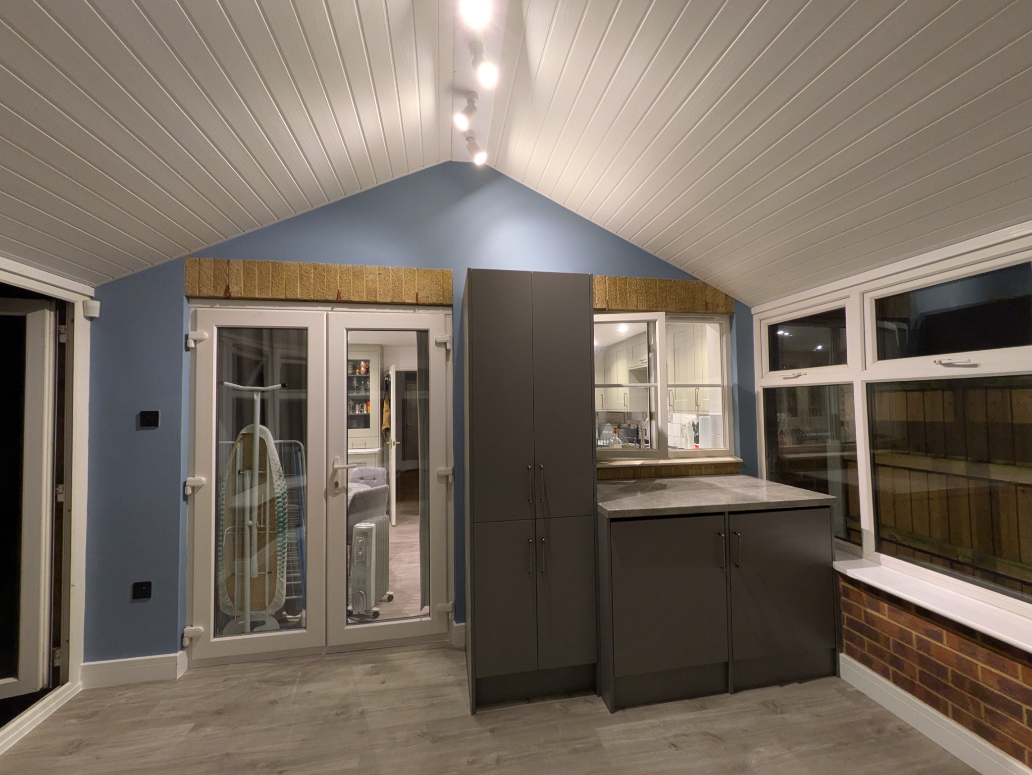 Renovated conservatory utility with fitted storage units, integrated appliances, new ceiling lighting and LVT flooring