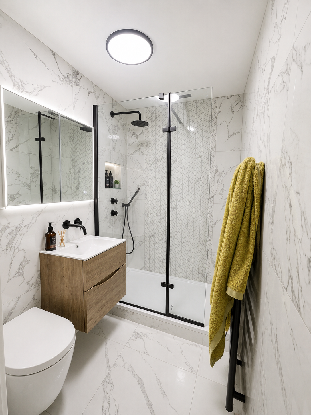 Modern bathroom refurbishment in Surrey with marble effect tiles, walk-in shower, floating vanity and black fixtures