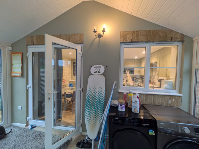 Conservatory before refurbishment in Aldershot with outdated flooring and limited storage